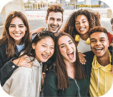 A group of friends laughing together, promoting youth wellness.