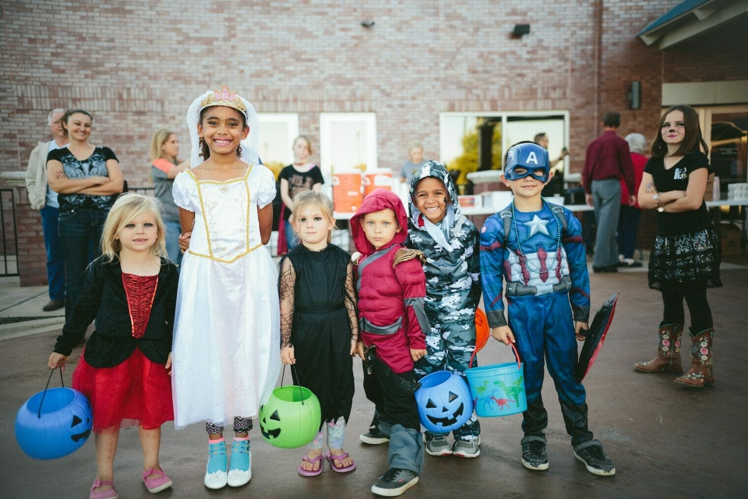 Cross Cultural Kids | curaJOY children standing while holding Jack 'o lantern and wearing costume